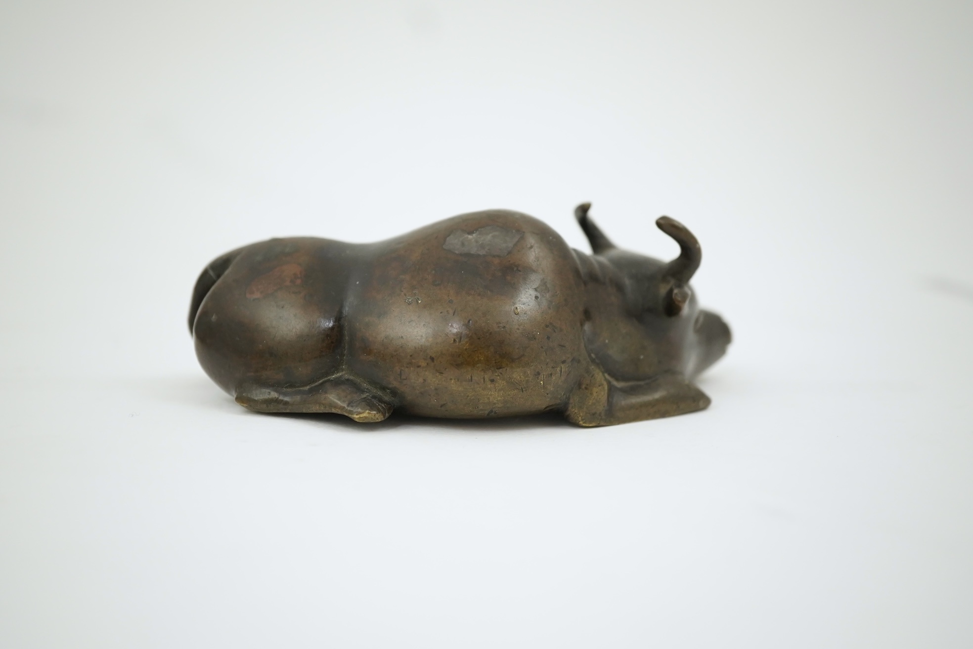 A Chinese bronze and mixed metal buffalo scroll weight, 19th century